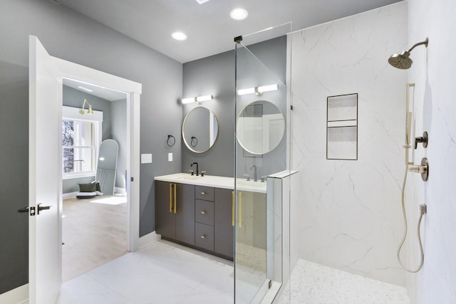 bathroom with vanity and a tile shower