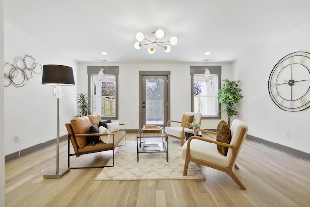 living area with light hardwood / wood-style flooring and a chandelier