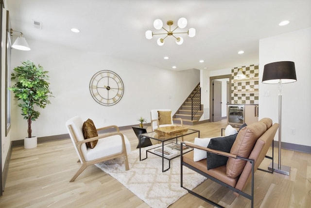 living room with wine cooler and light hardwood / wood-style floors