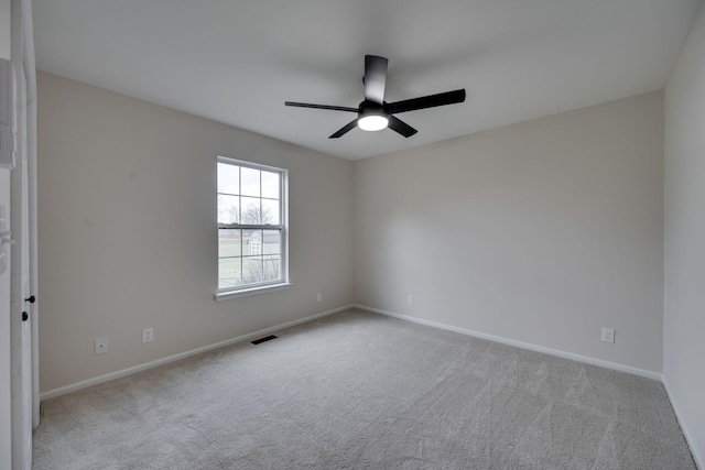 unfurnished room featuring light colored carpet and ceiling fan