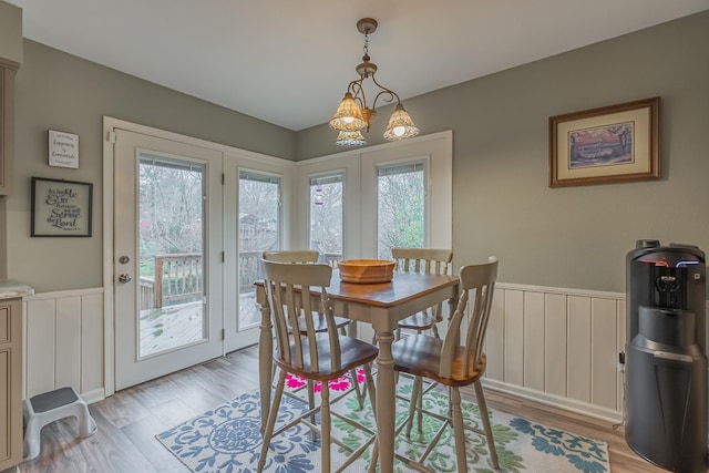 dining room featuring light hardwood / wood-style flooring and an inviting chandelier