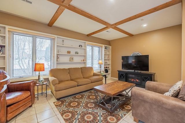 living room with beamed ceiling, built in shelves, light tile patterned flooring, and a fireplace