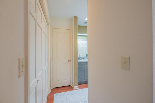 hallway with light hardwood / wood-style flooring