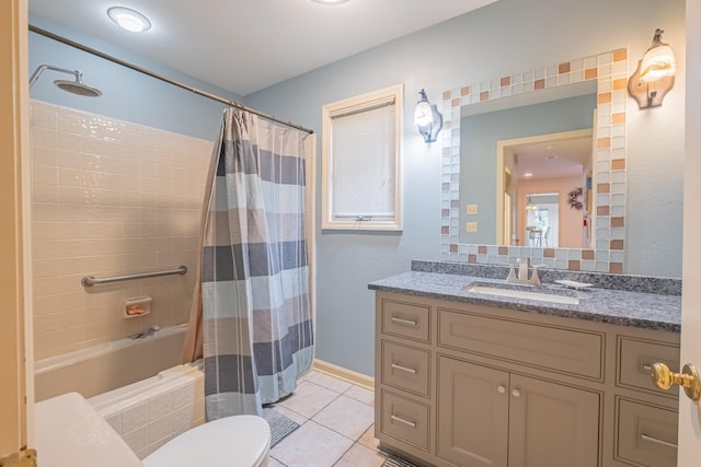 full bathroom with tile patterned floors, vanity, toilet, and shower / bath combo with shower curtain