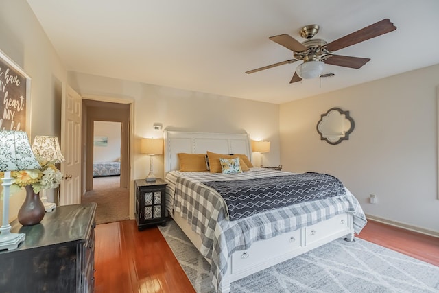 bedroom with hardwood / wood-style flooring and ceiling fan