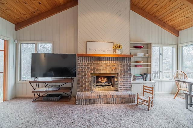 carpeted living room with a fireplace, wooden walls, and wood ceiling