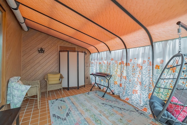 sunroom featuring vaulted ceiling