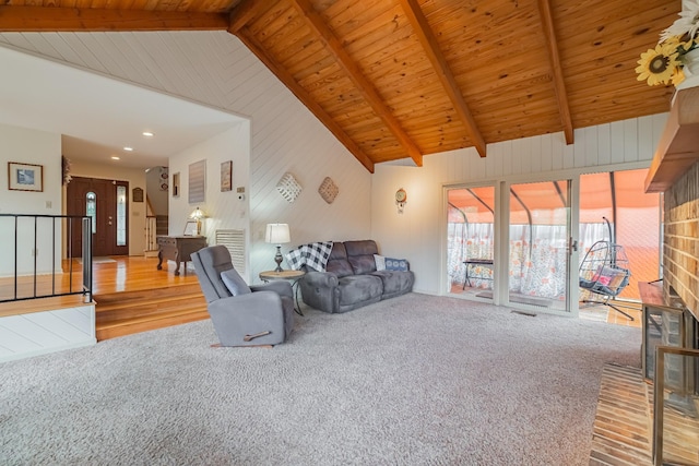 living room featuring a fireplace, hardwood / wood-style floors, lofted ceiling with beams, and wood ceiling