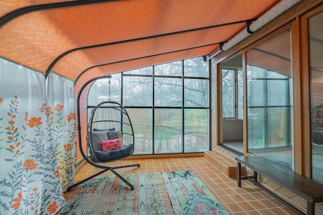 unfurnished sunroom with plenty of natural light and vaulted ceiling