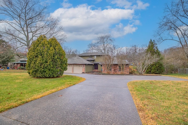 view of front facade featuring a garage and a front lawn