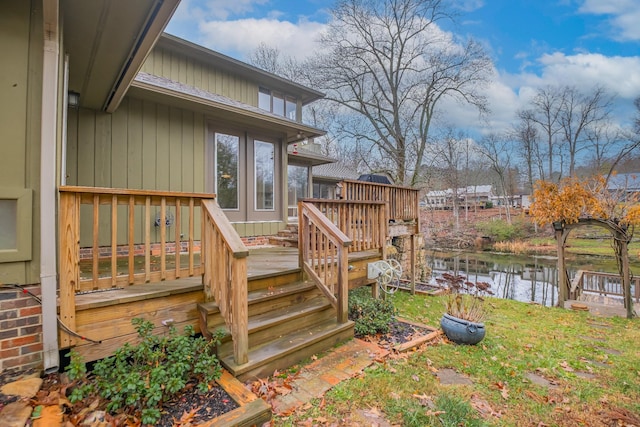 wooden terrace featuring a water view