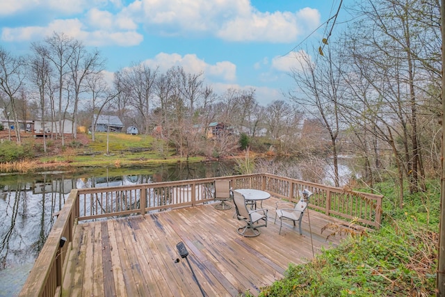 wooden terrace featuring a water view