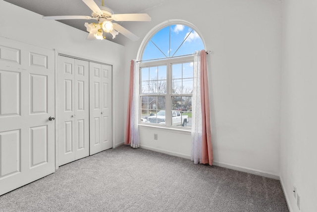 unfurnished bedroom featuring carpet flooring, ceiling fan, and a closet