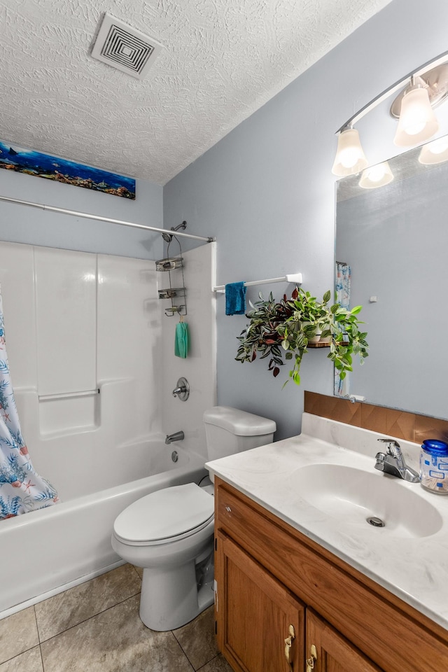 full bathroom featuring vanity, tile patterned flooring, toilet, shower / bathtub combination with curtain, and a textured ceiling