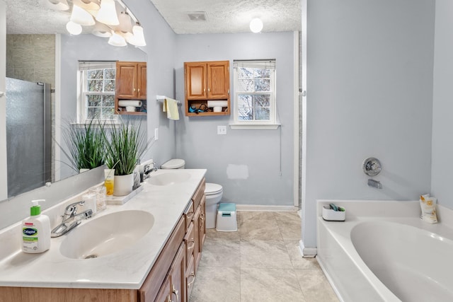 full bathroom with tile patterned floors, a textured ceiling, toilet, vanity, and independent shower and bath