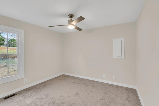 carpeted empty room featuring electric panel and ceiling fan