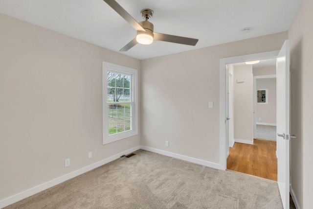 unfurnished room featuring light carpet and ceiling fan