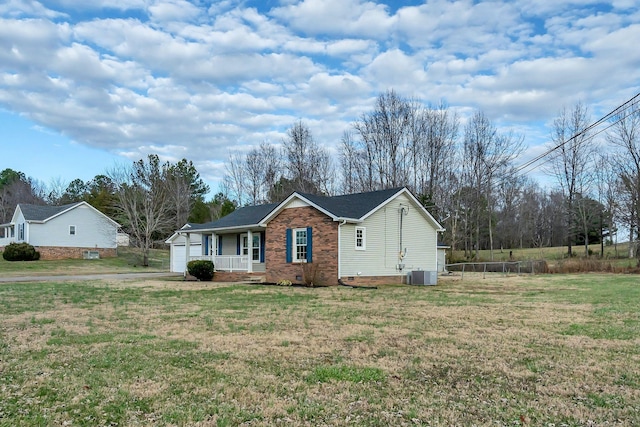 ranch-style home featuring central AC unit, a porch, and a front yard