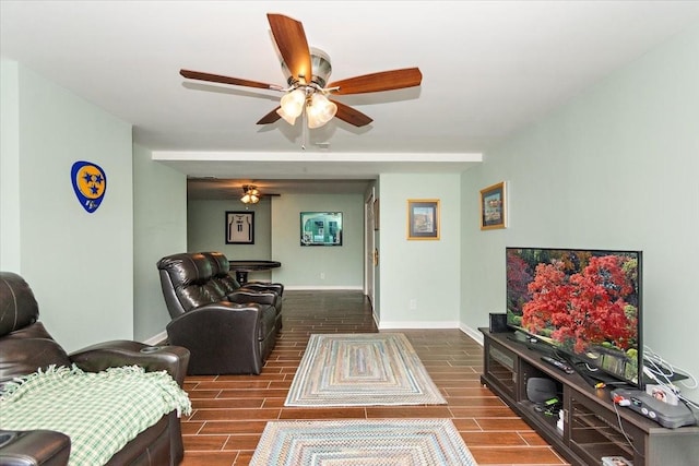 living room featuring dark hardwood / wood-style floors and ceiling fan