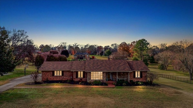 ranch-style home featuring a yard