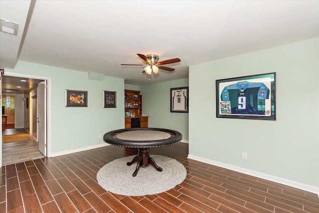 recreation room with dark hardwood / wood-style floors and ceiling fan