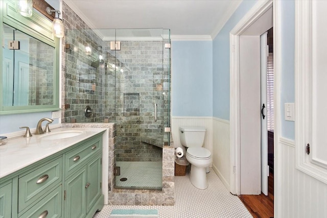 bathroom featuring tile patterned flooring, crown molding, an enclosed shower, toilet, and vanity