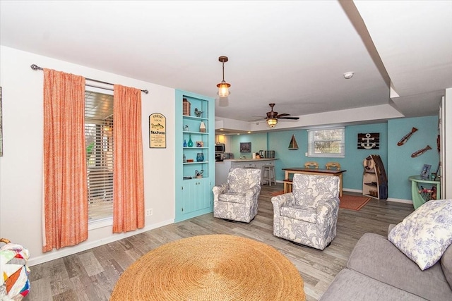 living room with ceiling fan and light wood-type flooring