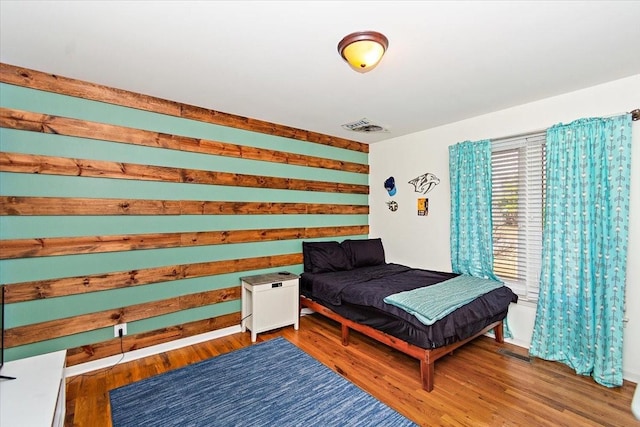 bedroom with hardwood / wood-style flooring