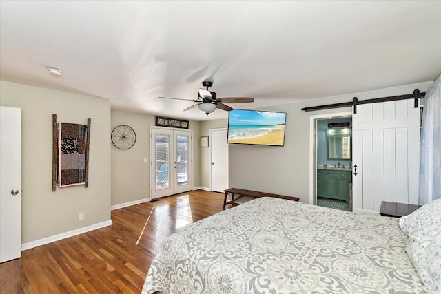 bedroom featuring hardwood / wood-style floors, access to outside, french doors, ceiling fan, and a barn door