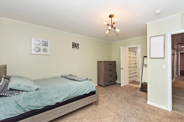 bedroom featuring light colored carpet, ornamental molding, and an inviting chandelier