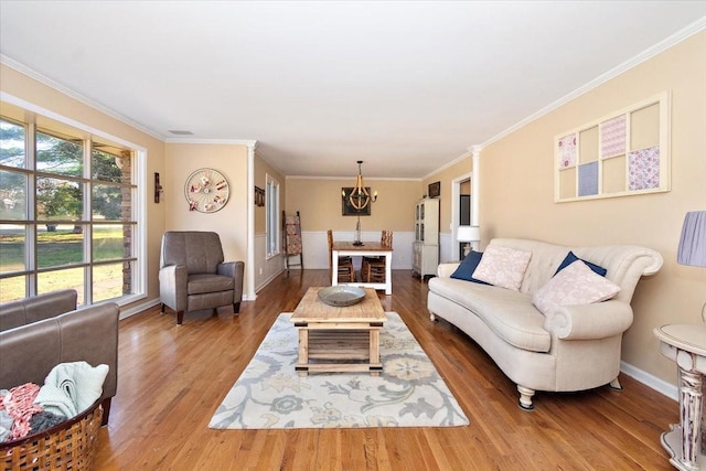 living room with wood-type flooring and ornamental molding