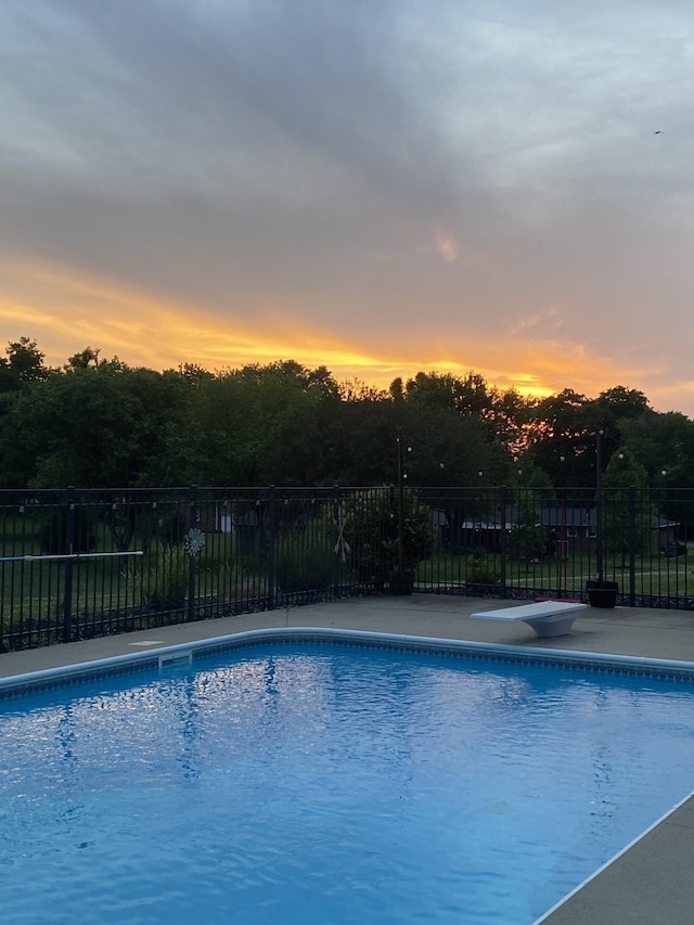 view of pool at dusk