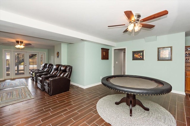 game room featuring ceiling fan, dark wood-type flooring, and french doors