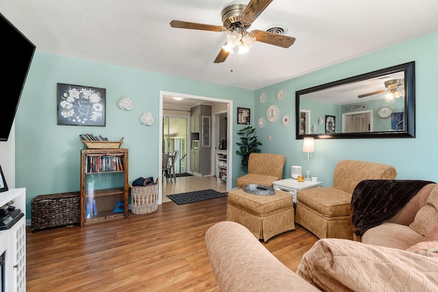 living room with hardwood / wood-style flooring and a textured ceiling