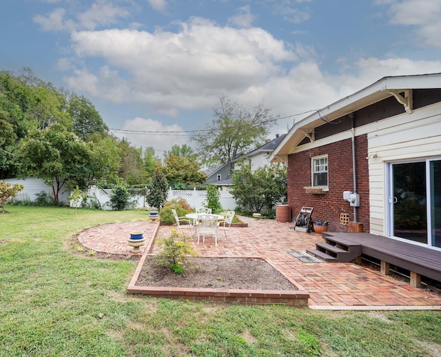 view of yard with a wooden deck and a patio area