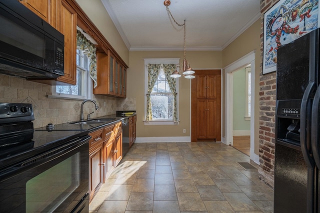 kitchen featuring sink, crown molding, pendant lighting, decorative backsplash, and black appliances