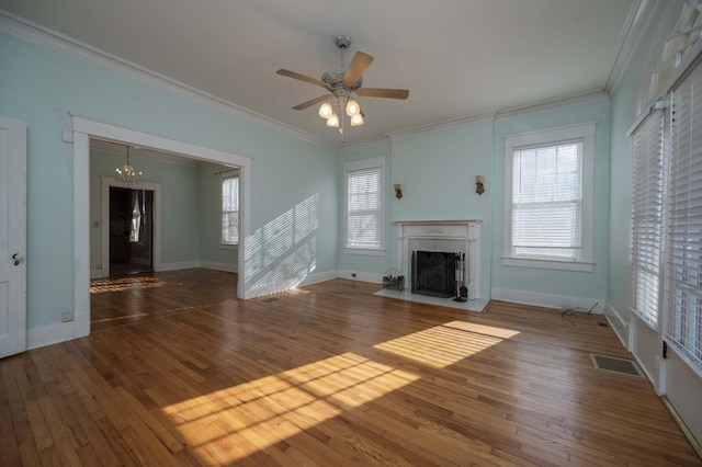 unfurnished living room featuring crown molding, dark wood-type flooring, and plenty of natural light