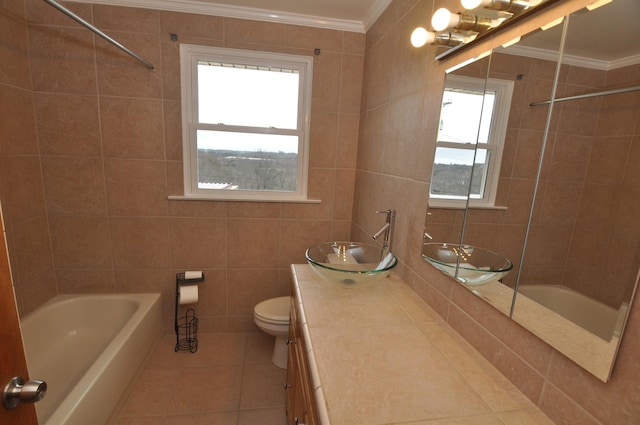 full bathroom featuring shower / bathing tub combination, tile walls, tile patterned flooring, vanity, and crown molding