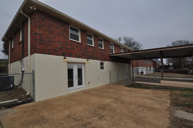 back of house with french doors and central AC unit