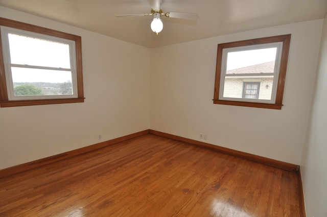 empty room featuring hardwood / wood-style floors and ceiling fan