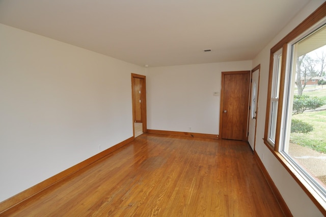 spare room with light hardwood / wood-style flooring