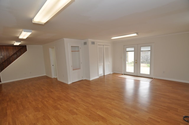 unfurnished room with ornamental molding, light hardwood / wood-style floors, and french doors