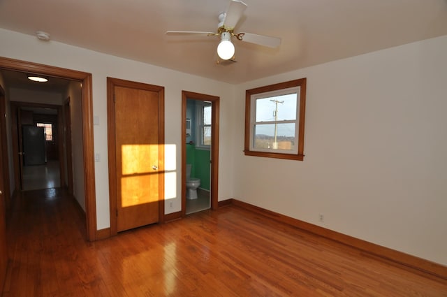 empty room featuring wood-type flooring and ceiling fan