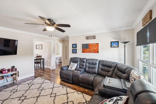 living room featuring dark hardwood / wood-style floors, ceiling fan, and crown molding