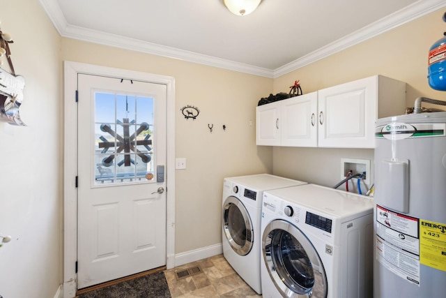 washroom with crown molding, electric water heater, washer and dryer, and cabinets