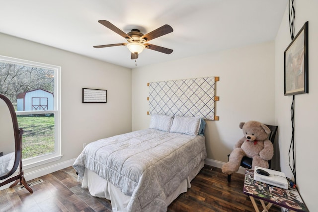 bedroom featuring ceiling fan and dark wood-type flooring