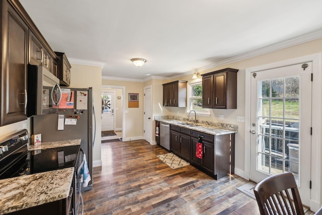 kitchen with dark brown cabinetry, light stone countertops, sink, and stainless steel appliances