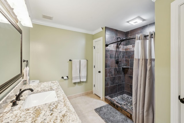 bathroom with tile patterned flooring, vanity, walk in shower, and ornamental molding