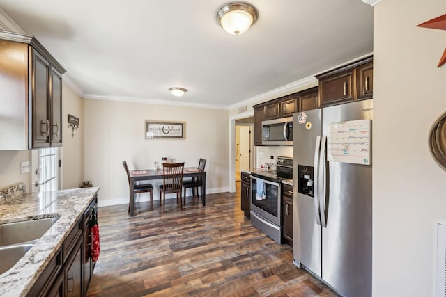 kitchen with sink, dark hardwood / wood-style floors, light stone countertops, appliances with stainless steel finishes, and dark brown cabinets