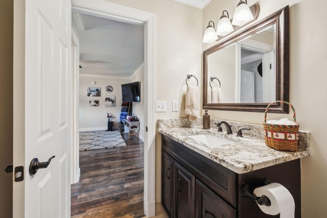 bathroom with vanity, wood-type flooring, and ornamental molding